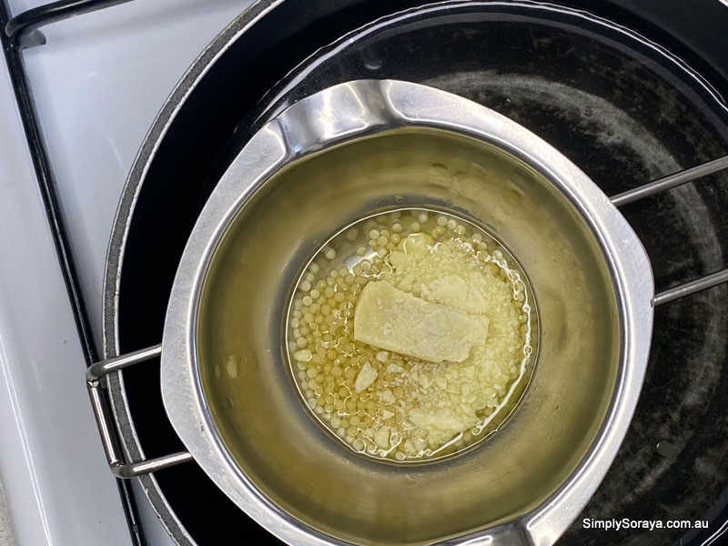 Melting all the ingredients to make cocoa butter lip balm