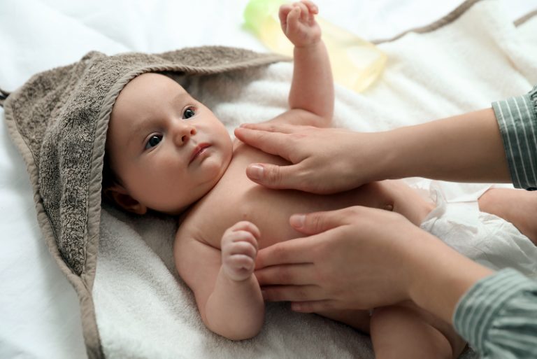 Massaging baby with coconut oil