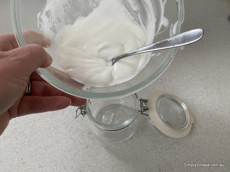 Placing the lotion in a cute bail jar
