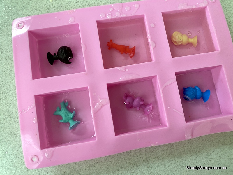 Pouring the soap on top of the toys