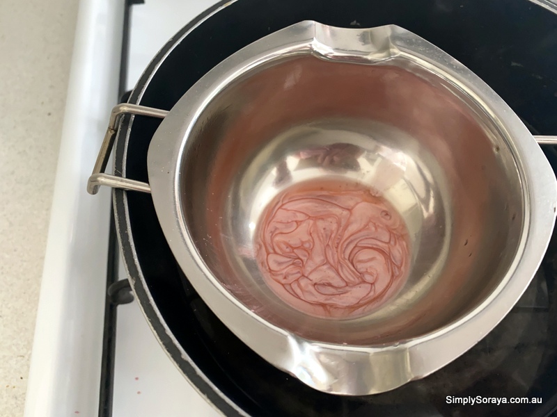Adding the mica powder to tint the lip balm
