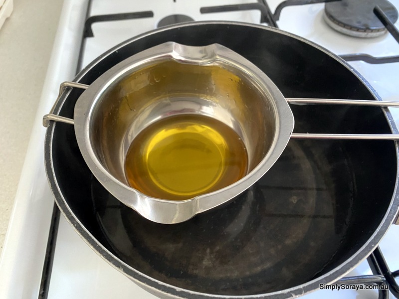 Mixing the beeswax, cocoa butter and coconut oil