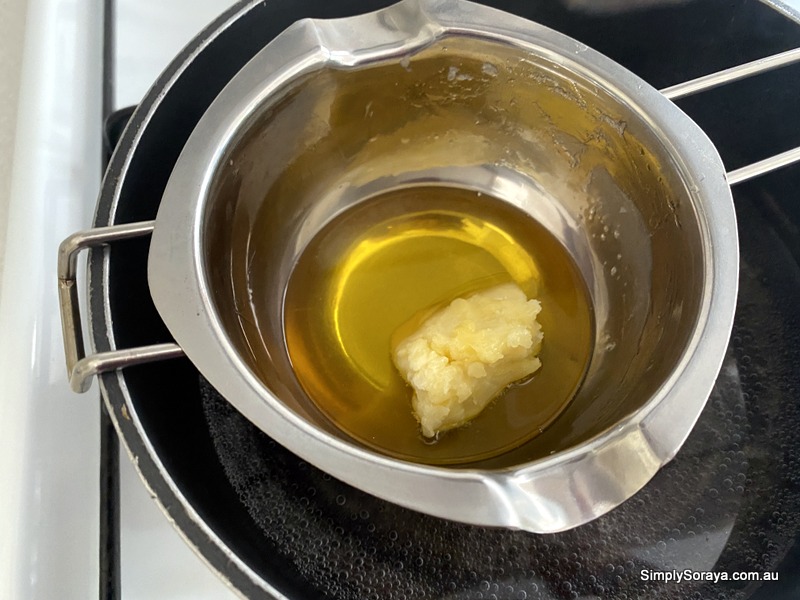 mixing in shea butter in double boiler